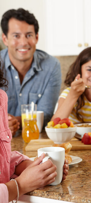 family eating together at kitchen counter