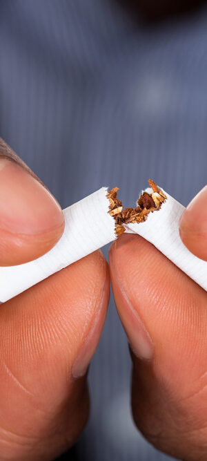 fingers breaking cigarette