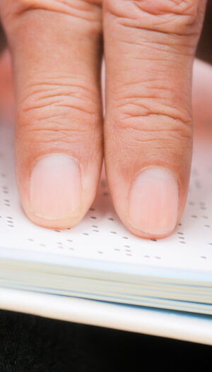 fingers on braille page