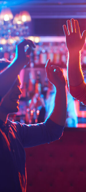 friends dancing at a bar