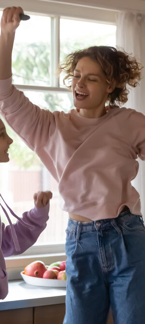 girl and mom dancing in kitchen