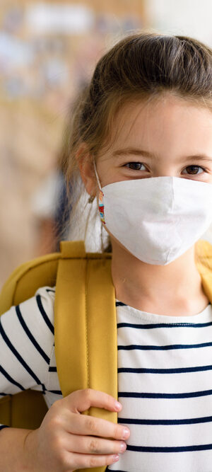 girl at school with face covering