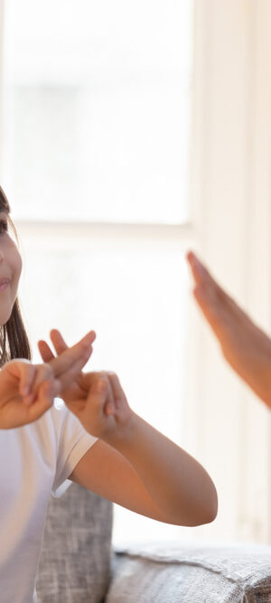 girl on couch using sign language