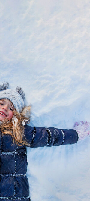 girl playing in the snow