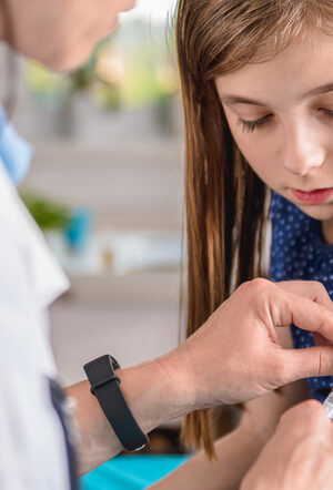 girl with long hair getting vaccine
