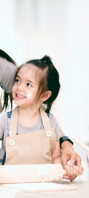 girl with mom using rolling pin