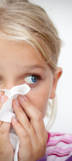 girl with tissue on nose