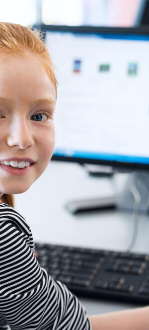 girl workong on computer and smiling