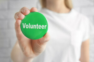green volunteer button