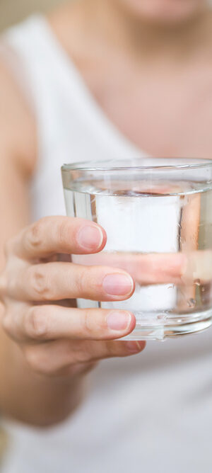 hand holding glass of water