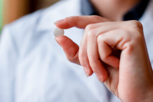 hand holding medication pill