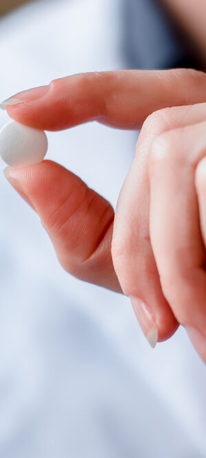 hand holding medication pill