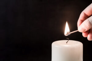 hand lighting candle