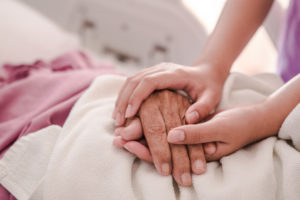 holder older hands in hospital
