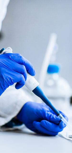 lab worker with blue gloves