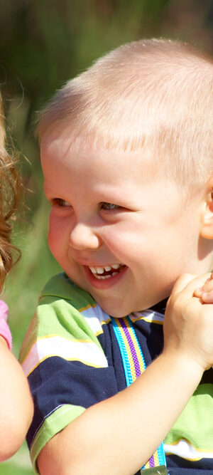 little boy and little girl playing outdoors