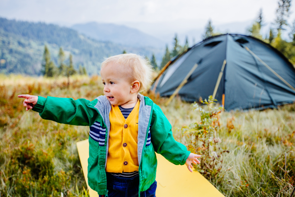 little boy by tent