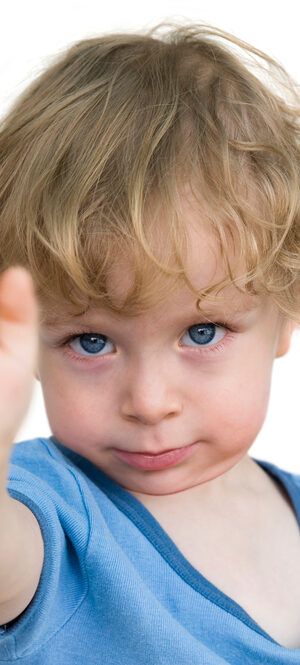 little boy holding up hand to say no