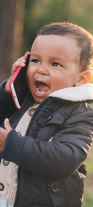 little boy outdoors with smartphone