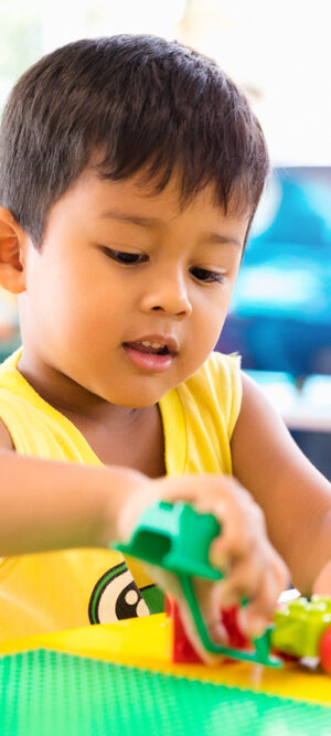 little boy playing with building toys