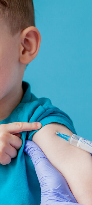 little boy with blue shirt getting shot