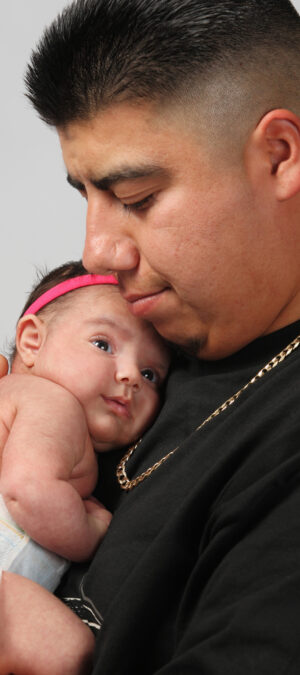 man holding newborn baby daughter