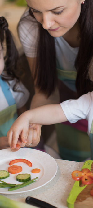 mom and little girls with vegetables