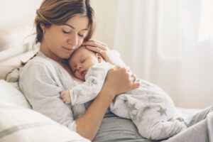mom holding sleeping infant