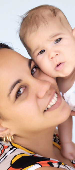 mom holding up newborn baby