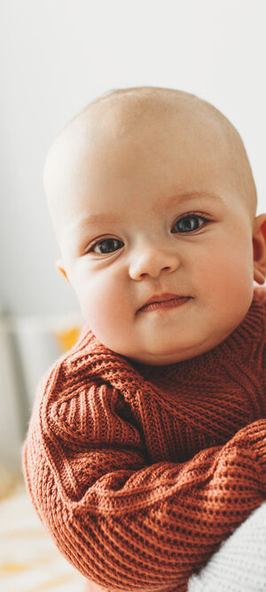 mom with baby wearing sweater