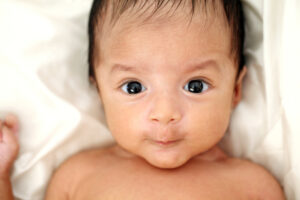 newborn baby with bright dark eyes