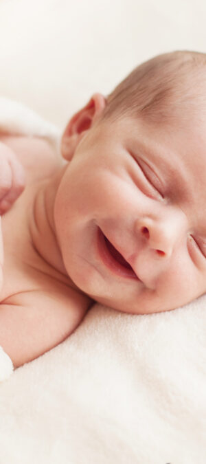 newborn baby with smile