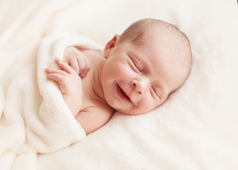 newborn with smile