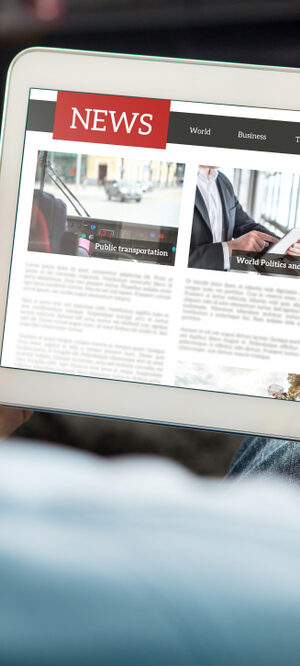 news on tablet with hands 2