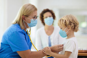 nurse and child with masks