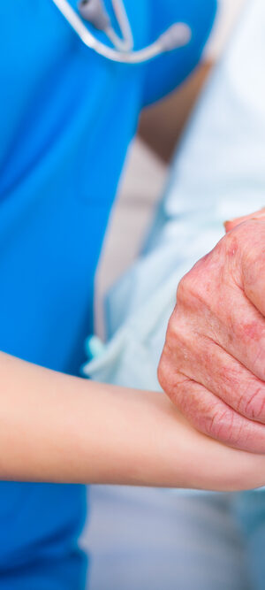nurse holding patient hand