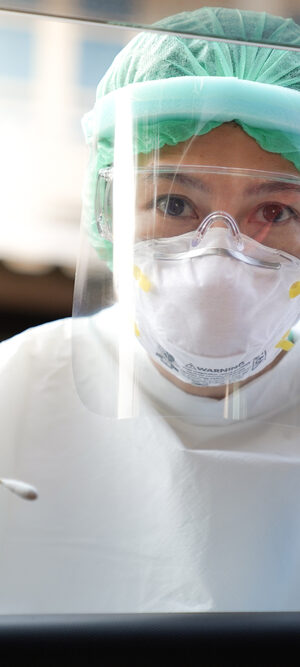 nurse with PPE and swab