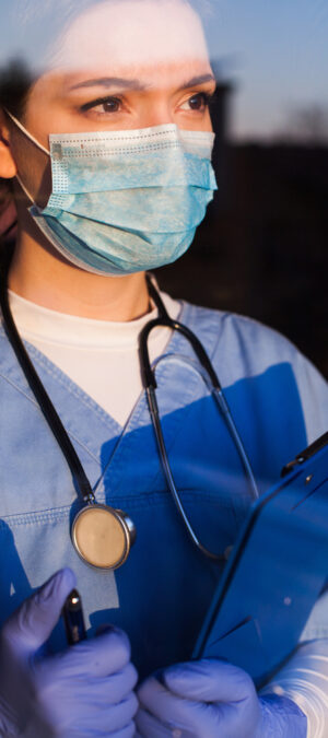 nurse with chart and mask