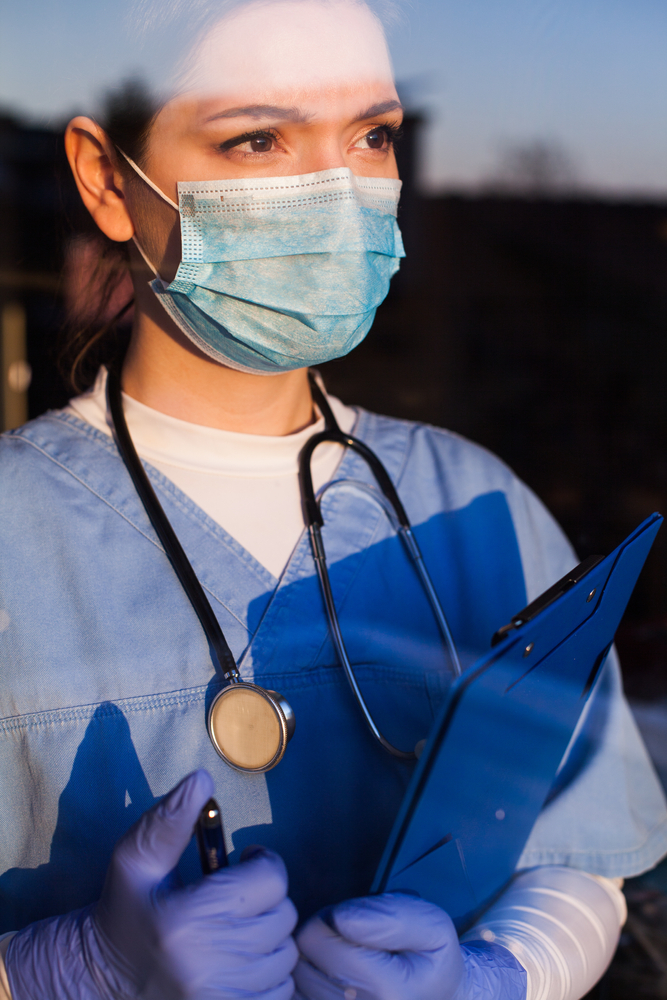 nurse with chart and mask