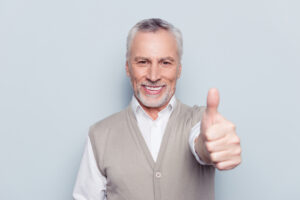 older man giving thumbs up