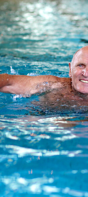 older man swimming in pool