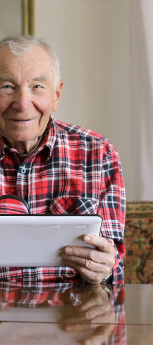 older man using tablet
