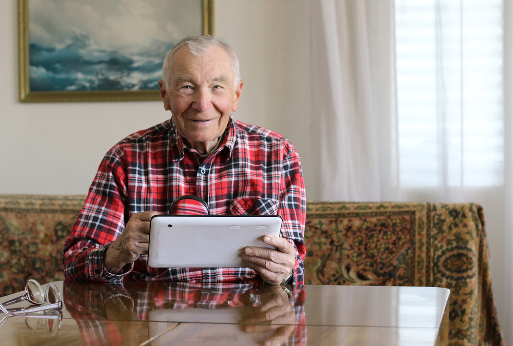 older man with tablet