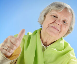 older woman giving thumbs up