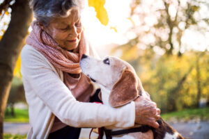older woman outdoors with dog