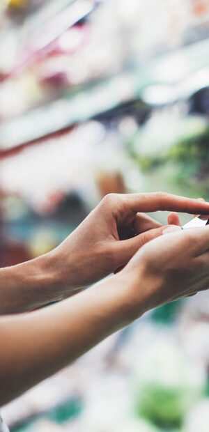 person looking at phone in store