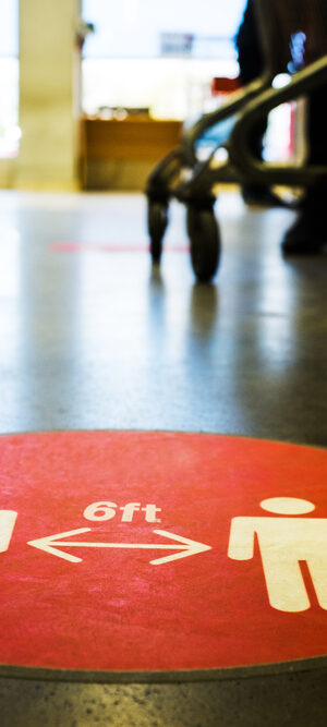 physical distancing sign on floor