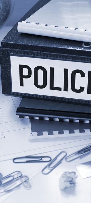 policies on binder on desk