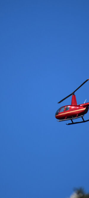 red helicopter with blue sky