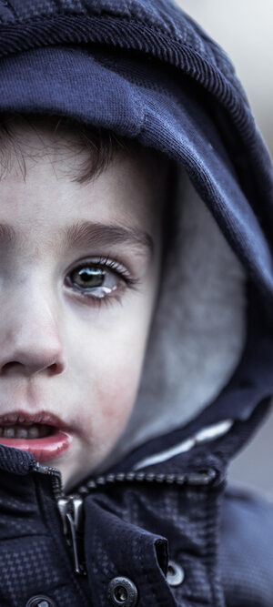 sad little boy with coat